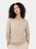 Woman wearing a beige cardigan against a white background #color_warm-grey