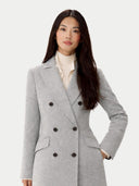 Woman wearing a gray double-breasted coat on a white background #color_vapor-blue