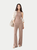 front view of a woman wearing a beige outfit with a white cardigan on a light gray background #color_timber-wolf