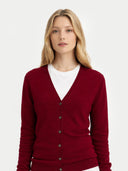 close up front view of Woman wearing a red v-neck cardigan over a white shirt on a light gray background #color_bordeaux