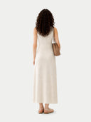 back view of a woman wearing a white dress holding a brown handbag on a white background #color_marshmallow