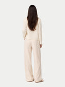 back view of a beige cardigan and pants on a white background #color_off-white
