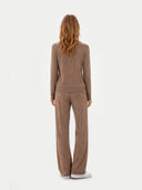 back view of a woman wearing a brown sweater and pants set on a white background #color_taupe