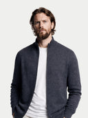 Man wearing a dark gray jacket over a white shirt on a light gray background #color_charcoal