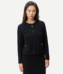 Woman wearing a black textured jacket on a white background