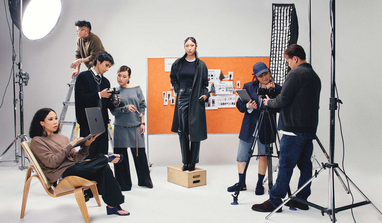 Film crew in a studio setting with equipment and actors.
