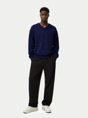 front view of a Man wearing a navy sweater and black pants on a white background #color_navy