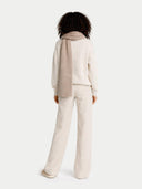 back view of person wearing a beige outfit with a scarf on a white background #color_taupe