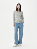 Person wearing a gray cardigan and blue jeans on a white background #color_dawn-blue