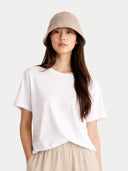 Woman wearing a white t-shirt and beige hat on a plain background #color_taupe