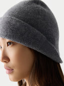 Person wearing a gray knit beanie against a neutral background #color_dim-gray