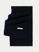 Black folded sweater with a visible brand label on a white background #color_black