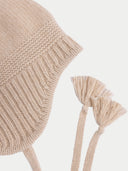 Beige knitted bonnet with tassels on a white background #color_beige