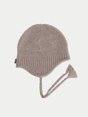 Knitted beanie with tassel on a light gray background #color_taupe