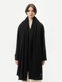 front view of woman wearing a black scarf and coat #color_black