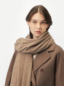 woman wrapping a brown scarf and coat #color_taupe