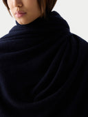 close-up view of a dark blue scarf with a neutral background #color_navy-blazer