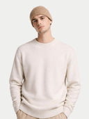 Man wearing a beige knit beanie and light gray sweater on a white background #color_taupe