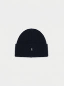 dark navy beanie with a small logo on a white background #color_navy-blazer