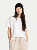 Person wearing a white t-shirt and beige pants on a plain background #color_black