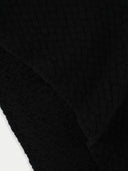 Close-up of a textured black fabric with a subtle pattern #color_black