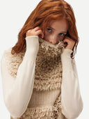 A woman wearing a beige loop-stitch gilet over white sweater #color_warm-grey