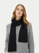 Woman wearing a black scarf and gray sweater on a white background #color_black