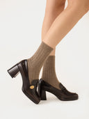 side view of posing walking model wearing taupe colored ribbed socks with high heels on a white background #color_taupe