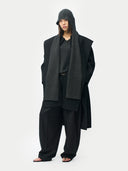 Person wearing a dark gray outfit with a black gray hood scarf on a white background #color_black