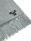 close up of a gray scarf with a small label "GOBI" #color_dim-gray