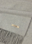 Gray scarf with a 'Gobi' label on a gray background #color_high-rise