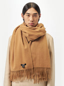 Person wearing a brown scarf with a visible brand label on a white background  #color_almond