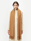 Woman wearing a brown scarf on a white background  #color_almond