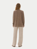 Back view of a woman wearing a brown sweater and beige pants on a white background #color_taupe
