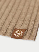 Brown textured fabric with a logo tag on a white background #color_taupe