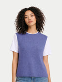 Woman wearing a blue and white sleeveless top against a plain background #color_crown-blue