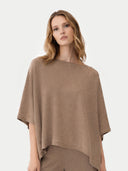 Woman wearing a brown poncho on a white background #color_taupe