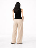 back view of  a black sleeveless top and beige pants on a white background #color_black