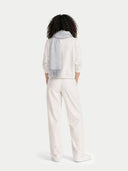 back view of person wearing a light gray sweater and white pants on a white background #color_high-rise