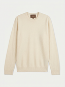 flat lay of a light beige crew neck sweater on a light gray background.