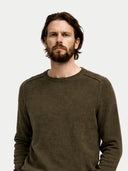 Man wearing a dark green sweater against a white background #color_burnt-olive