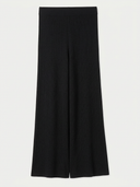 Black wide-leg cropped trousers with a vertical ribbed texture, shown flat against a light off-white background.