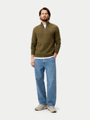 Man wearing a green sweater and blue jeans on a white background #color_cub