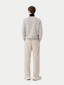 back view of a person wearing a gray sweater and beige pants on a white background #color_dawn-blue