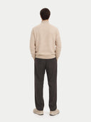 back view of a Person wearing a beige sweater and dark pants on a white background #color_beige