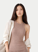 Woman wearing a beige sleeveless top and light-colored cardigan on a white background #color_timber-wolf