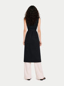 back view of a black sleeveless dress with white pants on a white background #color_black