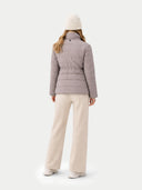 Back view of a person wearing a light gray puffer jacket and white pants on a white background #color_cement