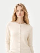 Woman wearing a beige cardigan on a white background  #color_off-white