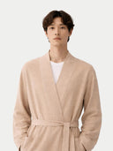 close up of Man wearing a beige robe against a white background #color_beige